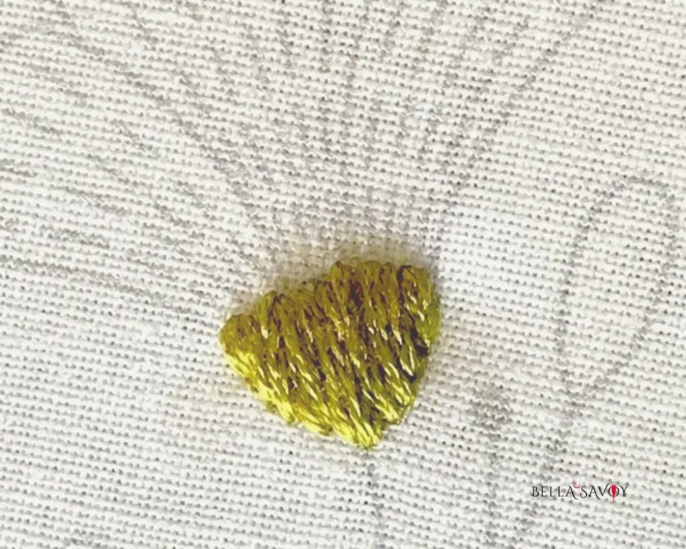 flower receptacle filled in with a green satin stitch