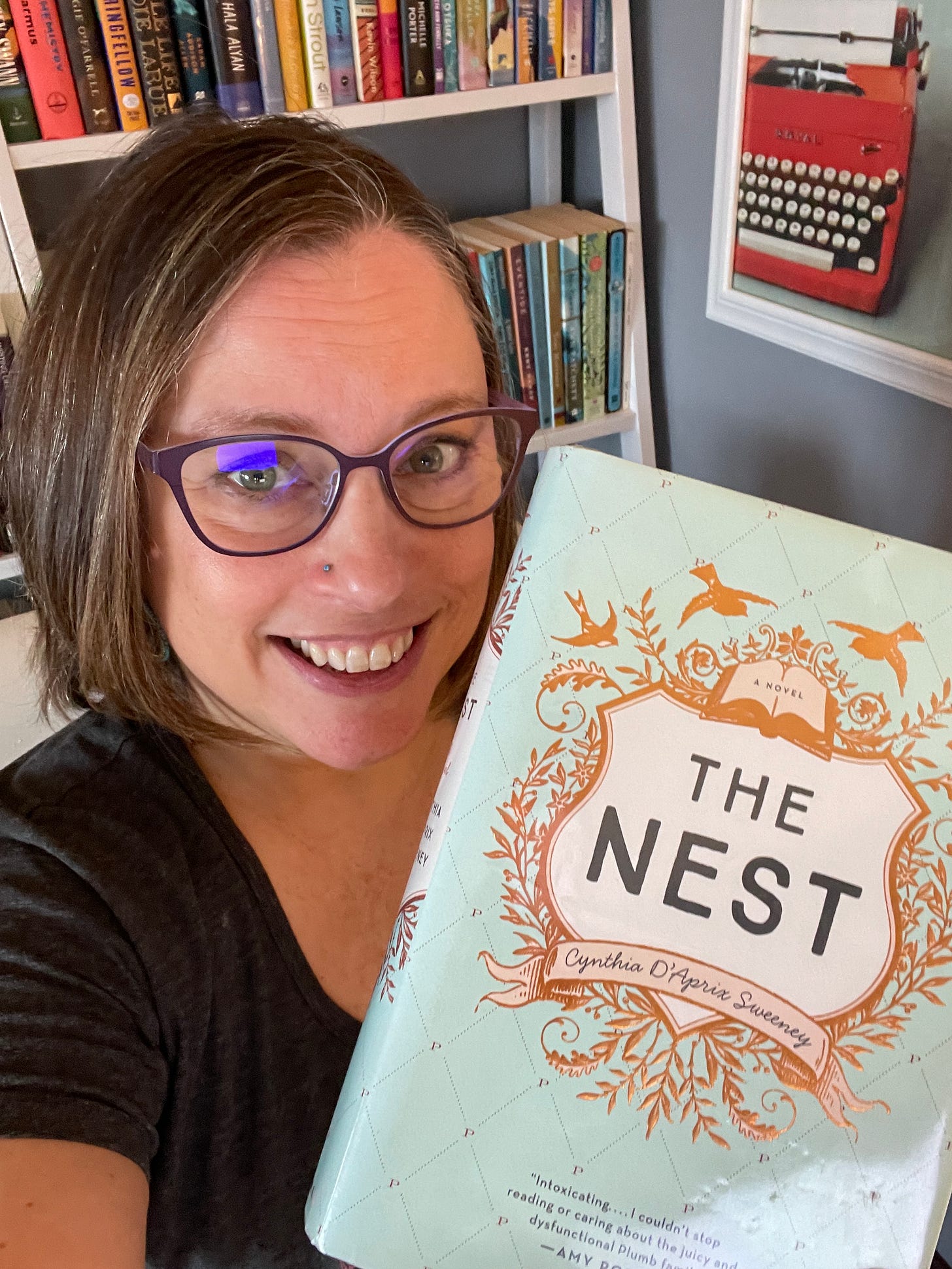 Stephanie holding a copy of The Nest
