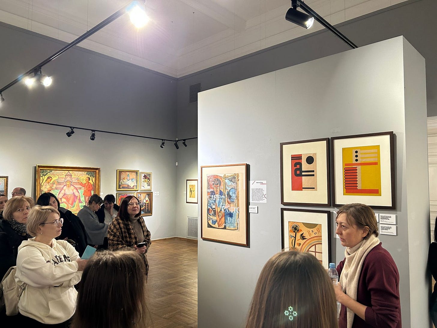 Visitors view paintings at an art exhibition in Lviv.