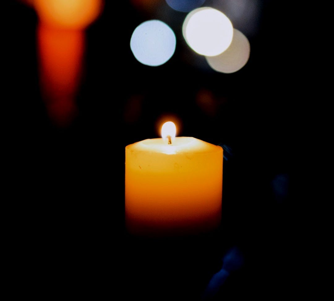 selective focus photography of lighted yellow candle