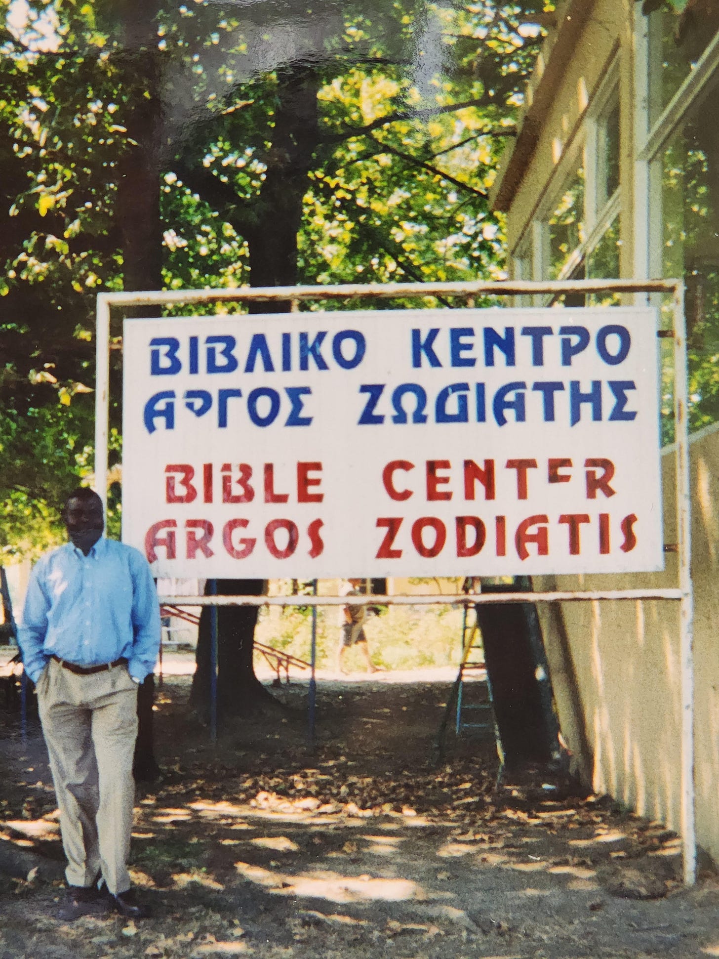 Man outside Bible school in West Africa