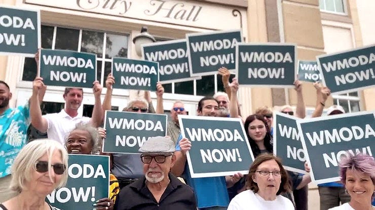 WMODA supporters gather outside City Hall in early March for a WPTV camera crew. (WPTV) WMODA supporters gather outside City Hall in early March for a WPTV camera crew. (WPTV)