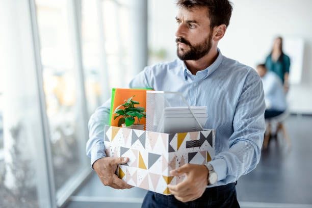 Leaving the office Business, Firing and Job Loss Concept - Sad Fired Male Office Worker With Box of His Personal Stuff layoff stock pictures, royalty-free photos & images