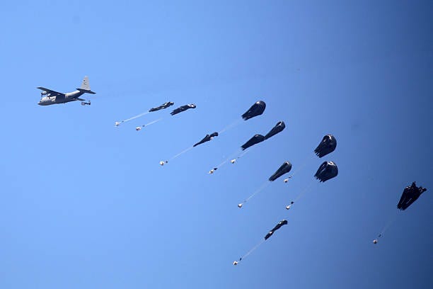 Military aircraft drops humanitarian aid over Nuseirat in the central Gaza Strip on August 3, 2025. Aid agencies have warned that Gaza's population...