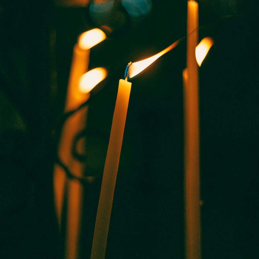 a group of lit candles sitting next to each other