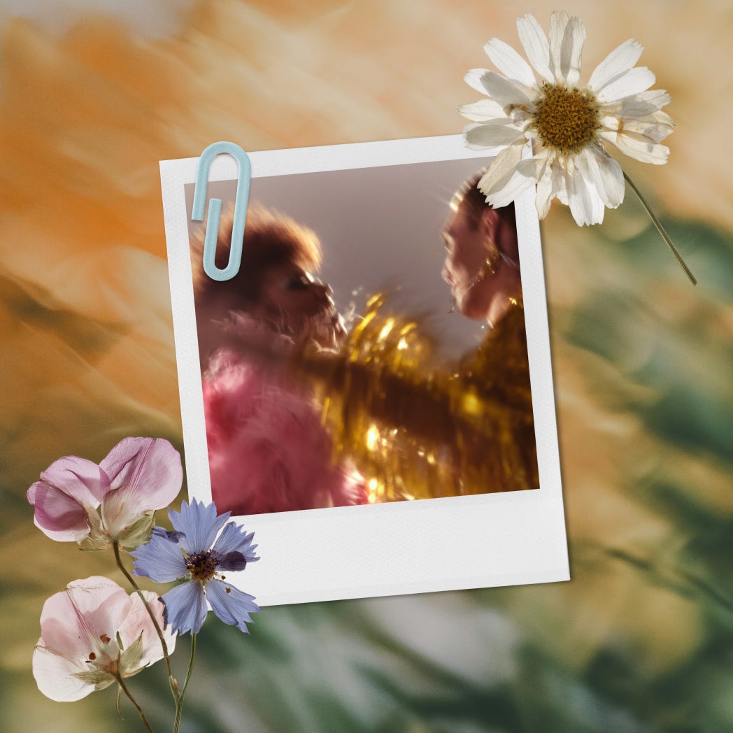 Blurry Polaroid-style photo of two people celebrating, layered with flowers.