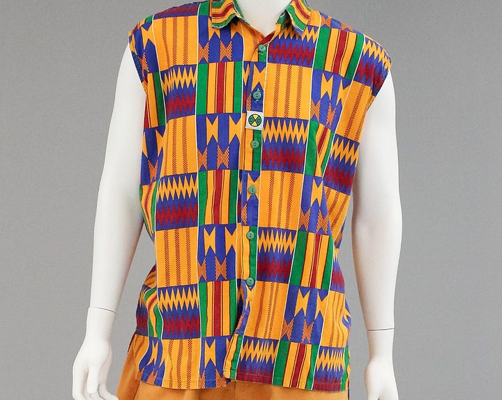 Images of brightly coloured shorts with graffiti, white t-shirt with the words Speak Yo Mind, multicolored cap with the words Cross Colours K-9 Club and image of a dog, and yellow, red, green, and blue patterned kente cloth shirt. 
