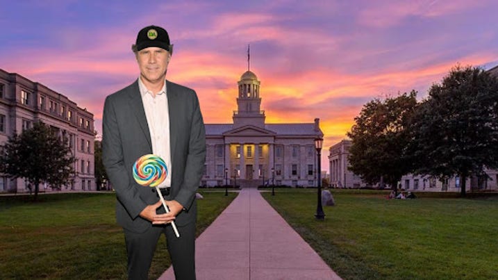 Will Ferrell holding a lollipop and wearing a Doily Allergen hat on the University of Iowa Pentacrest.