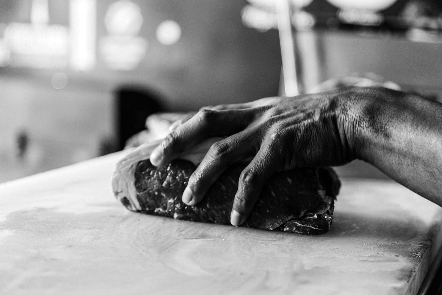A butcher holding a piece of meat in his hand in Boca del Río A butcher holding a piece of meat in his hand in Boca del Río