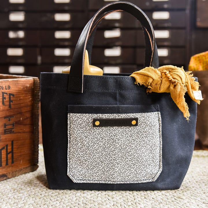 waxed canvas tote with vegetable tanned leather and antique textiles