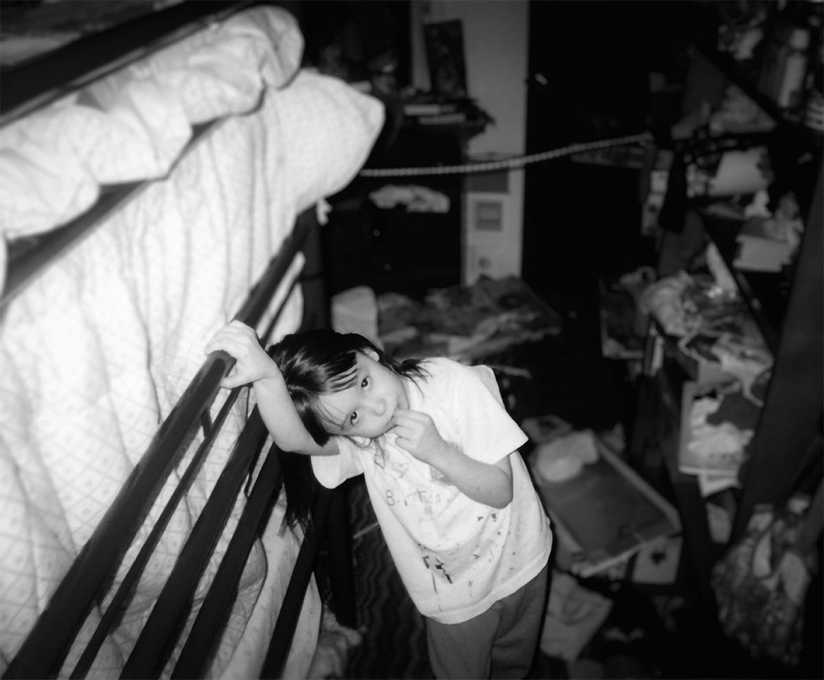A small, innocent-looking child stands in front of an unholy mess