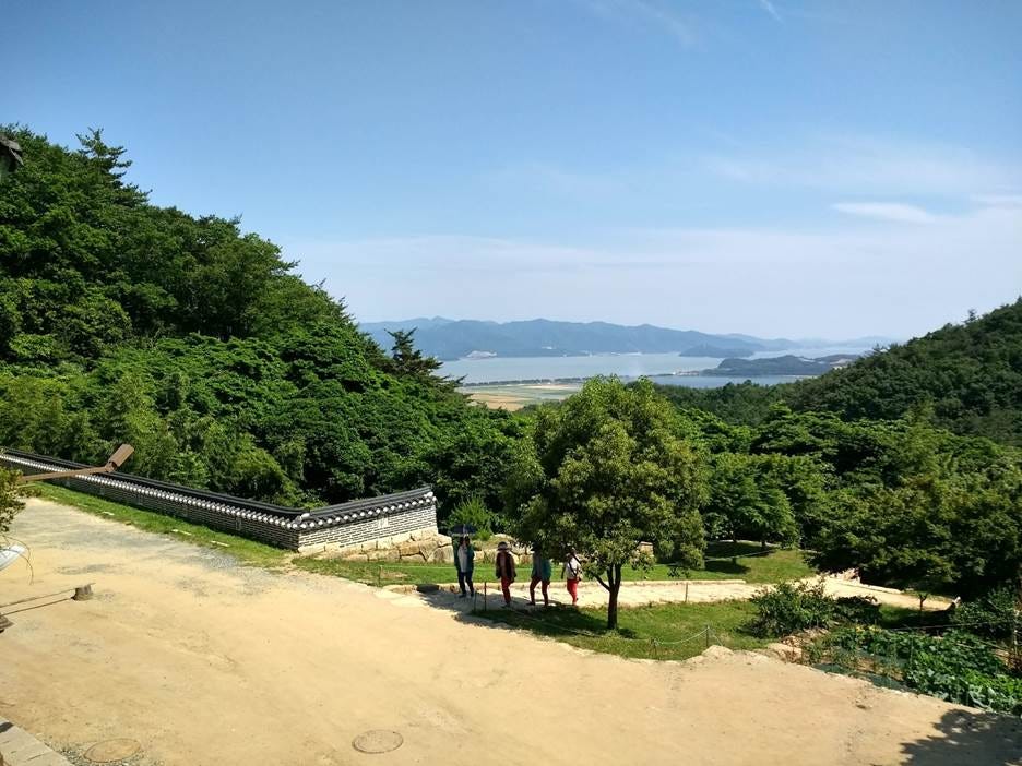 A group of people walking on a dirt path with trees and a body of water in the background
AI-generated content may be incorrect. A group of people walking on a dirt path with trees and a body of water in the background
AI-generated content may be incorrect.
