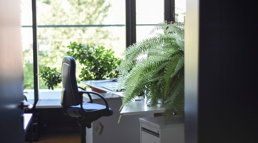 black leather rolling armchair near white wooden desk black leather rolling armchair near white wooden desk