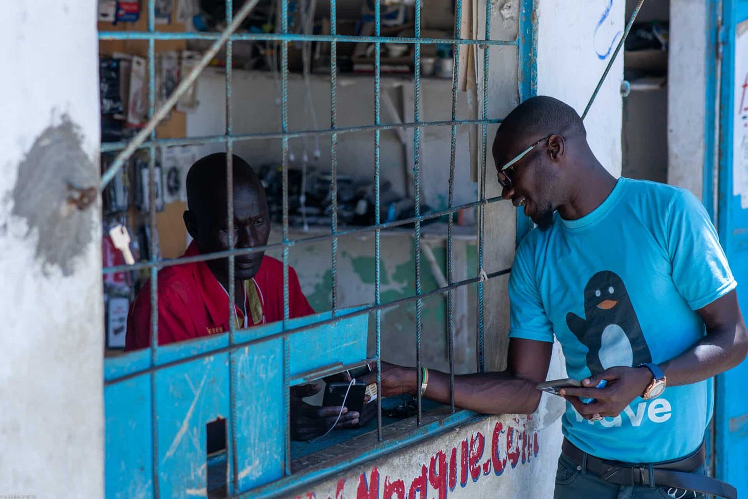 African man withdrawing cash from a Wave mobile money agent shop