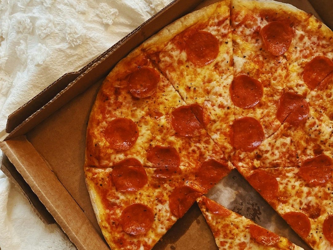 pizza on brown cardboard box
