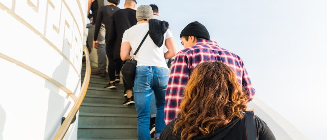 group of people on stairs under clear white sky group of people on stairs under clear white sky