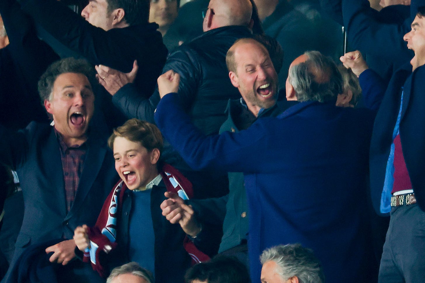 Men cheering at a football match