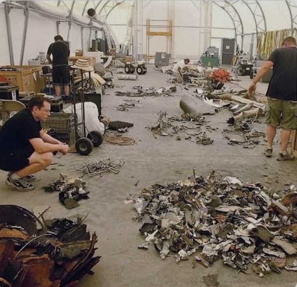 The SpaceX team sorting through Falcon 1 wreckage The SpaceX team sorting through Falcon 1 wreckage