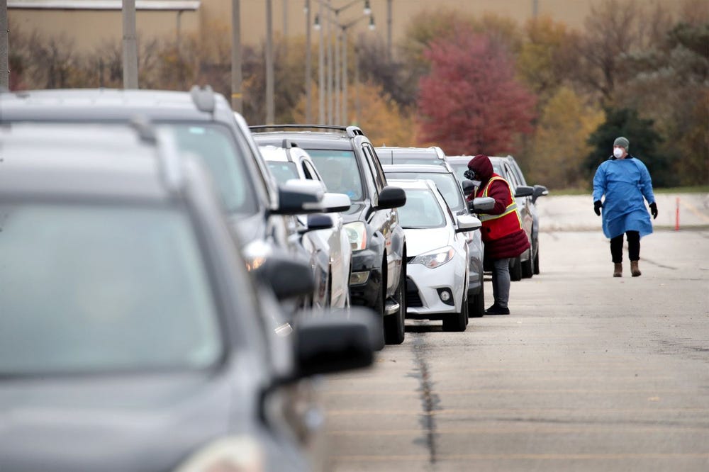 Cars line up at covid-19 mobile test center in Milwaukee, Wisconsin on Thursday.