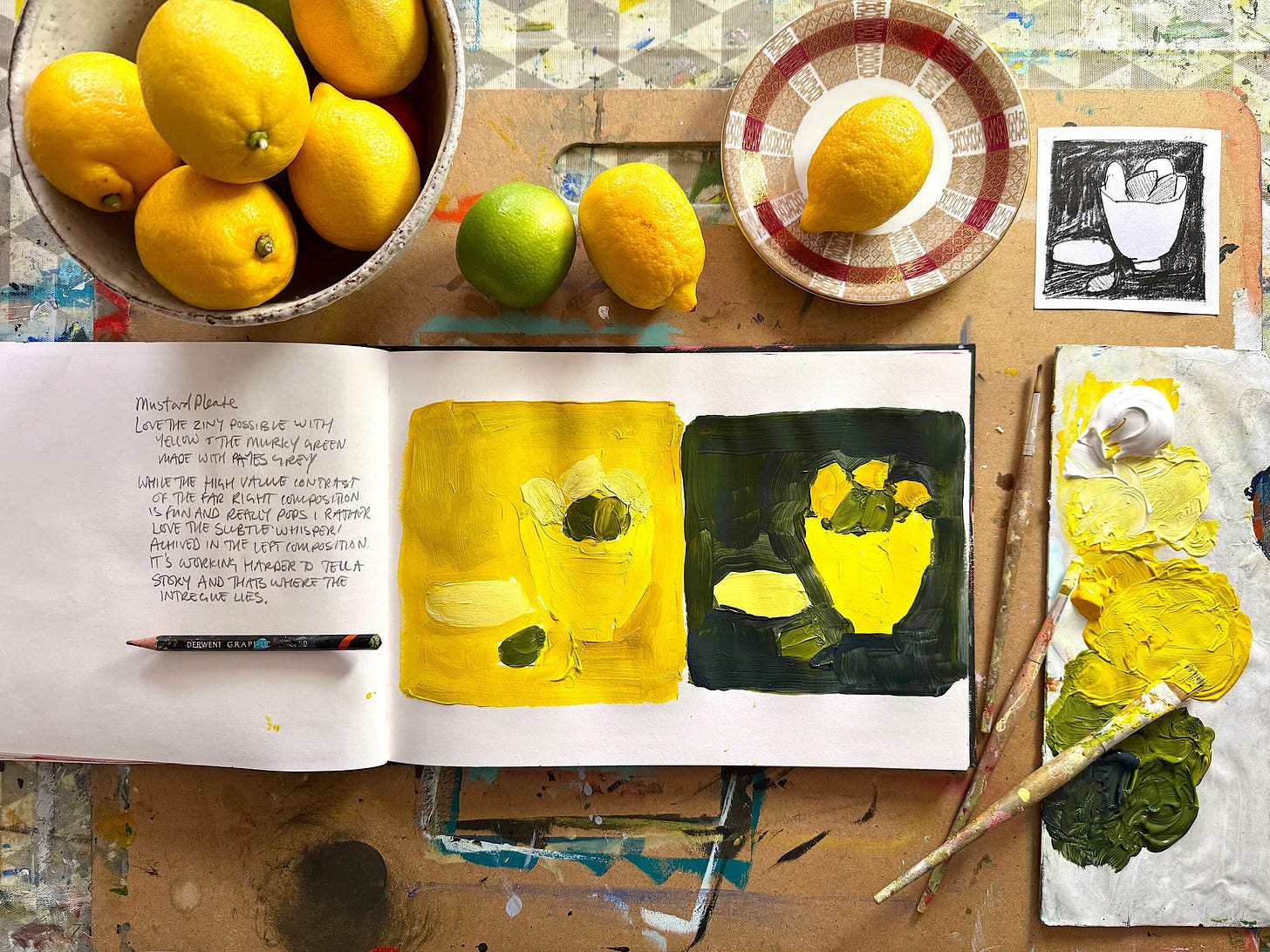 An overhead, flat-lay view of an open artist's sketchbook surrounded by studio materials and fresh fruit. On the right-hand page, two square acrylic studies explore value contrast: one in monochromatic bright yellows and the other featuring a high-contrast bright yellow composition against a murky, dark green background. The left page contains handwritten artist notes and a graphite pencil. Surrounding the sketchbook are a ceramic bowl filled with bright yellow lemons, a single green lime, a patterned red and white saucer holding another lemon, paintbrushes, a small black-and-white thumbnail sketch, and a paint palette covered in thick dollops of yellow, white, and green paint. An overhead, flat-lay view of an open artist's sketchbook surrounded by studio materials and fresh fruit. On the right-hand page, two square acrylic studies explore value contrast: one in monochromatic bright yellows and the other featuring a high-contrast bright yellow composition against a murky, dark green background. The left page contains handwritten artist notes and a graphite pencil. Surrounding the sketchbook are a ceramic bowl filled with bright yellow lemons, a single green lime, a patterned red and white saucer holding another lemon, paintbrushes, a small black-and-white thumbnail sketch, and a paint palette covered in thick dollops of yellow, white, and green paint.