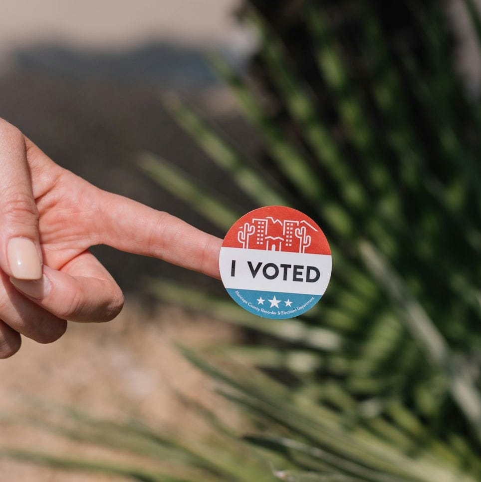 person holding red and white round pin