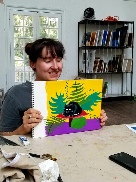 Happy painters holding up their Mary Blair-inspired paintings.