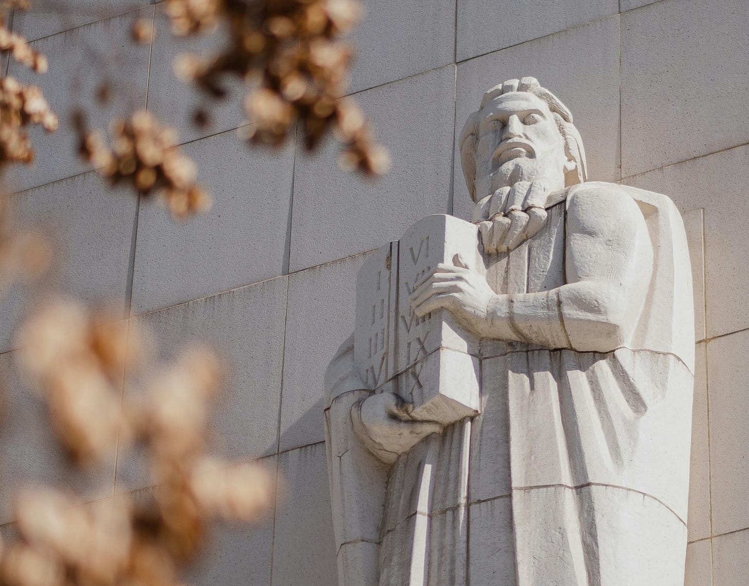 Photo of a statue of Moses hold the stone tablets of the law.