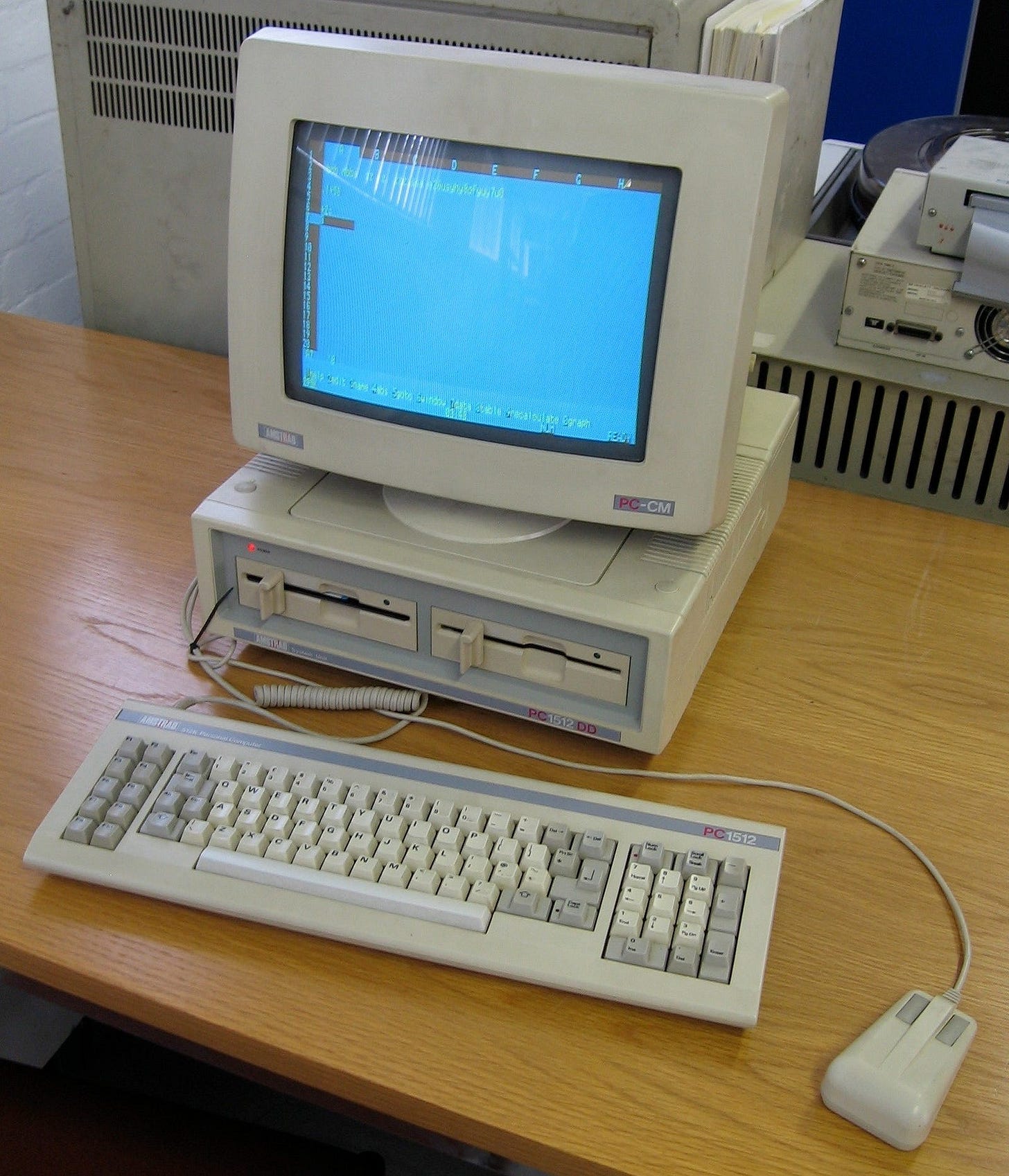 Amstrad PC1512 computer with monitor, keyboard, and mouse. 
