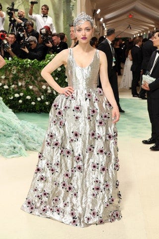 Image may contain Amanda Seyfried Person Clothing Dress Formal Wear Adult Wedding Fashion Gown and Wedding Gown