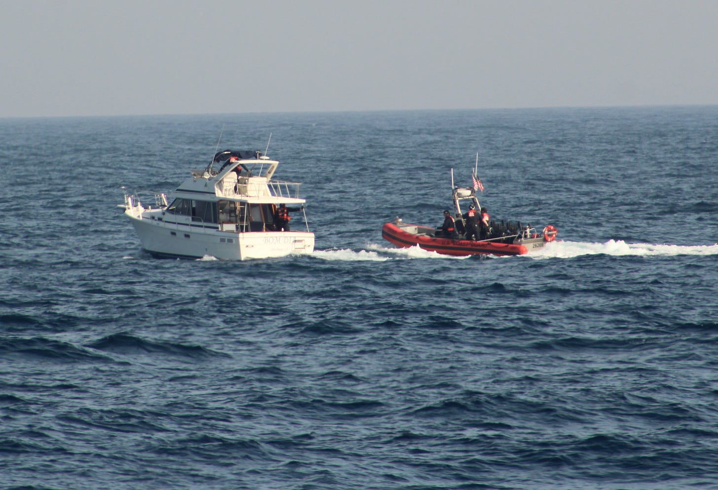 A Coast Guard boarding party approaches a boat with 36 illegal aliens aboard near San Diego. (US Coast Guard photo)