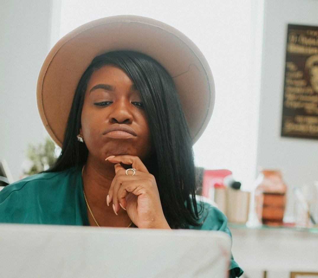woman in green shirt wearing white hat