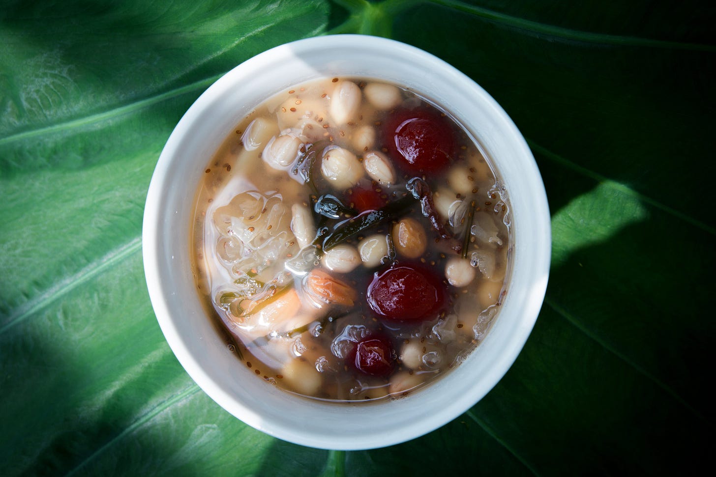 An overhead view of a mug of bean soup.