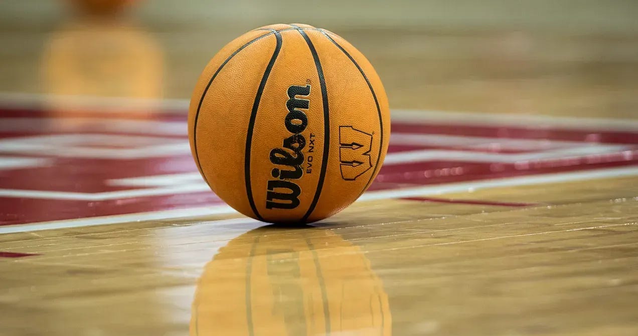 A Wisconsin Badgers-branded basketball sits on the Kohl Center floor. 