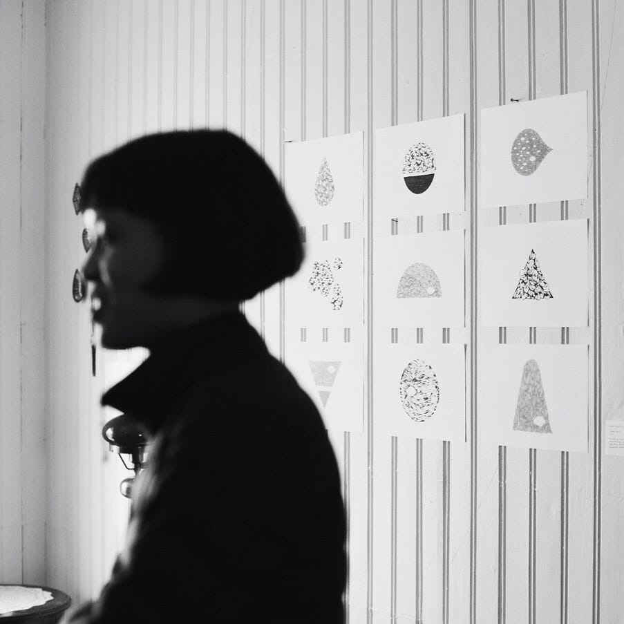 A picture of Helen speaking in front of their growth spells, pinned on a wall.