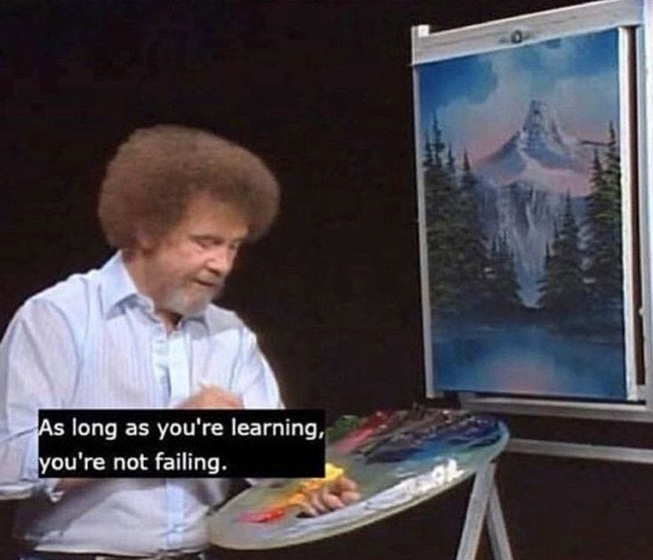 This may contain: a man sitting in front of a easel with a painting on it's side