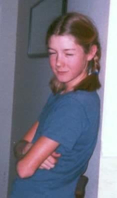 weirdo preteen glaring with crossed arms and pigtails