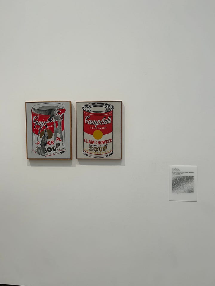Andy Warhol's soup cans, Jeff Koons' Balloon Dog (Blue), neon lights with various phrases on them, such as "they tried to bury us but they didn't know we were seeds," and Hannah in the Infinity Room