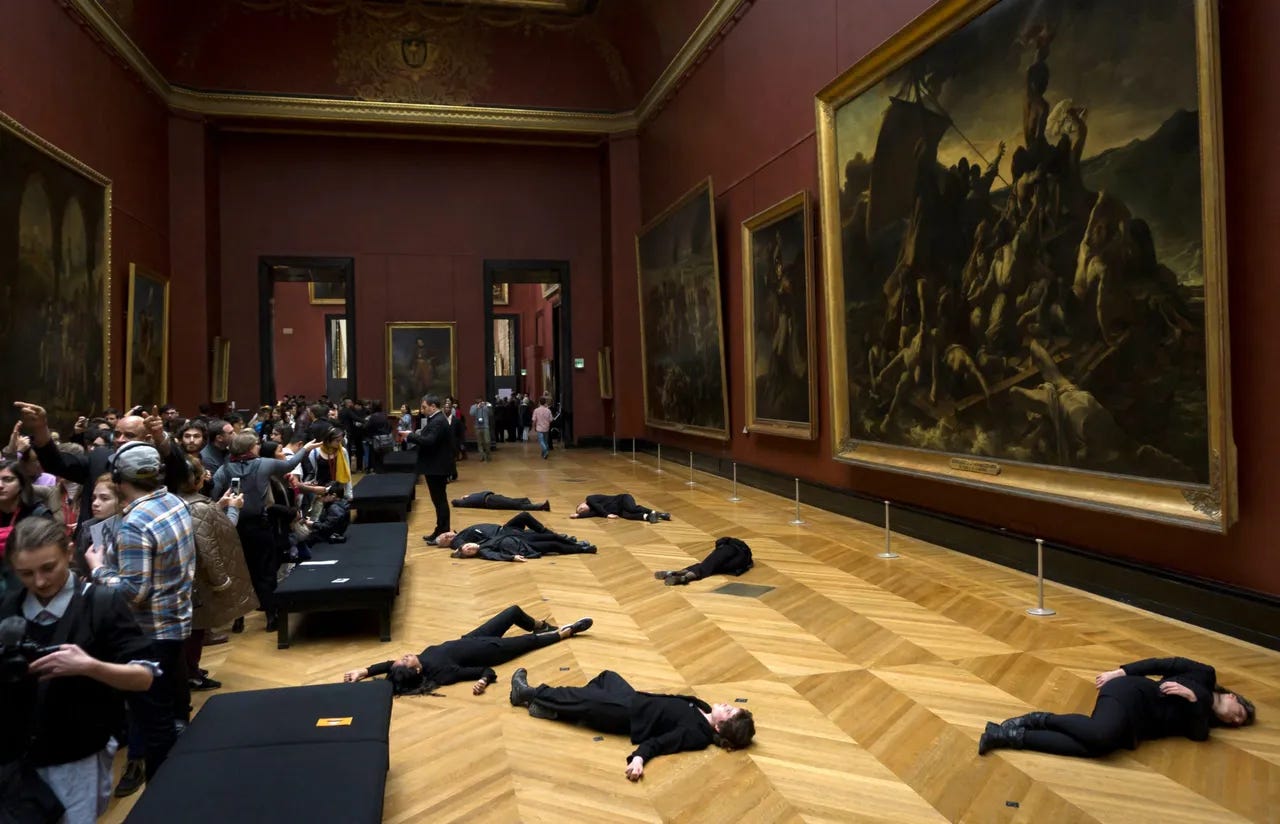 Members of the environmental activist group '350.org' lie on the floor in front of Theodore Gericault's painting "The Raft of the Medusa" at The Louvre Museum in Paris on March 12, 2018, as they seek to denounce the sponsorship partnership between the French museum and the Total energy company. (Photo by THOMAS SAMSON/AFP via Getty Images)