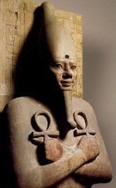 an egyptian statue with two symbols on it's chest and arms wrapped around the body an egyptian statue with two symbols on it's chest and arms wrapped around the body