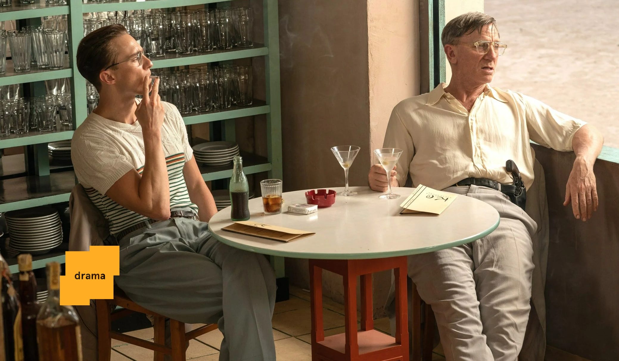 Drew Starkey as Eugene and Daniel Craig as Lee have a drink in a scene in Queer