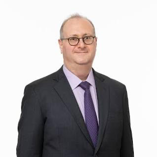 A person in a suit and tie

Description automatically generated