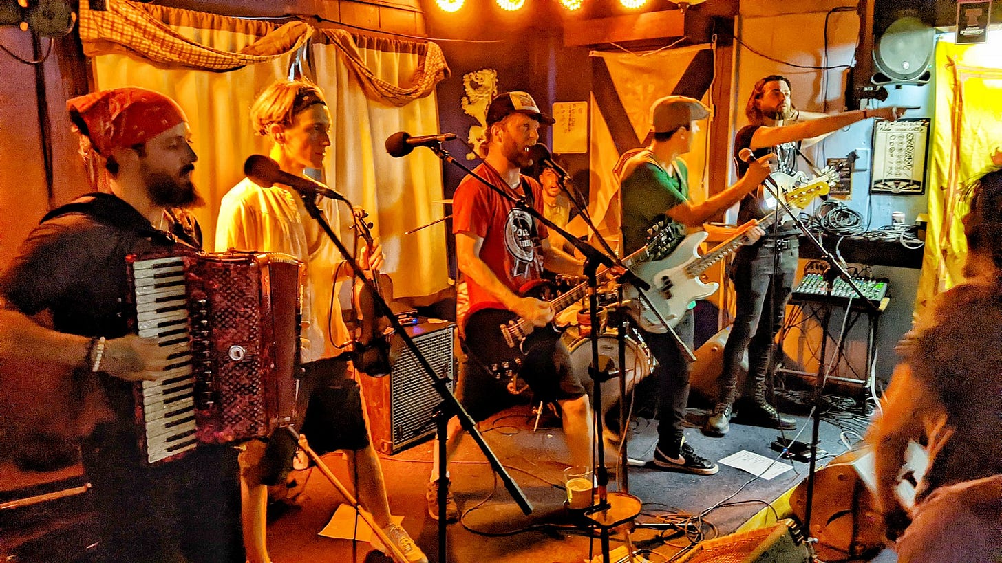 May be an image of 5 people, accordion, violin, guitar and clarinet