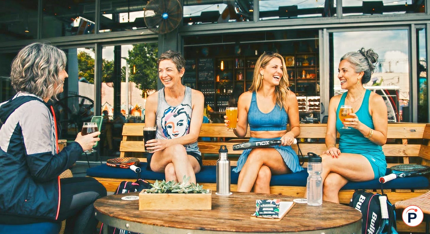 femmes de 40 ans qui boivent un verre après un match de padel