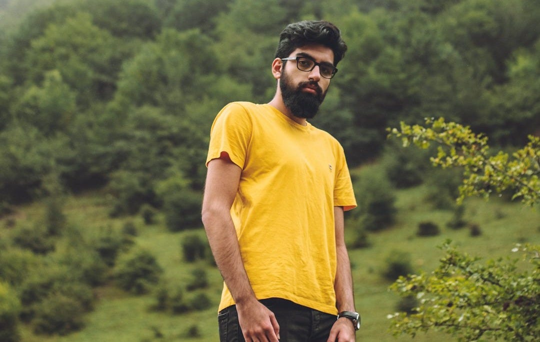 man wearing yellow crew-neck t-shirt