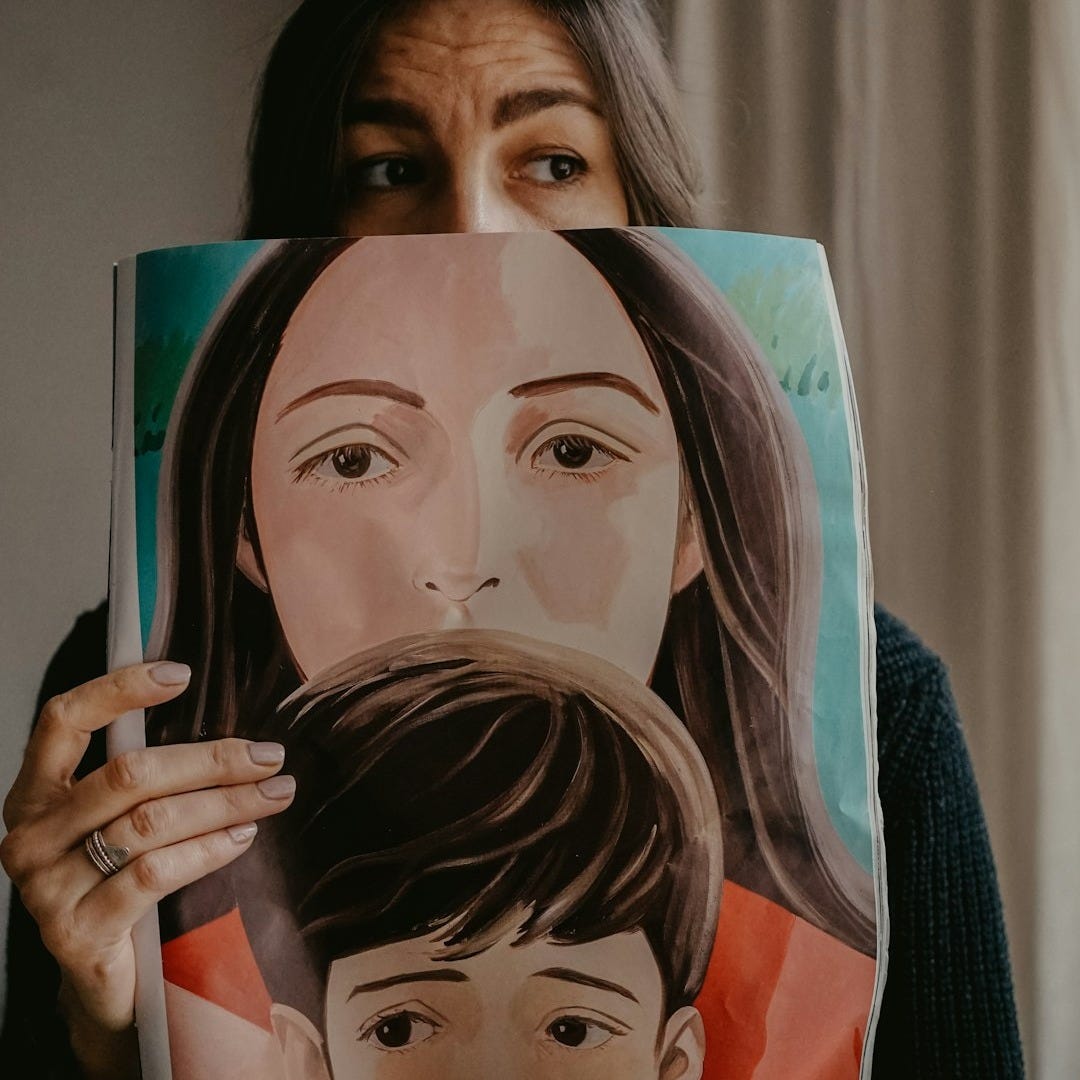 woman in black knit sweater covering her face with her hand