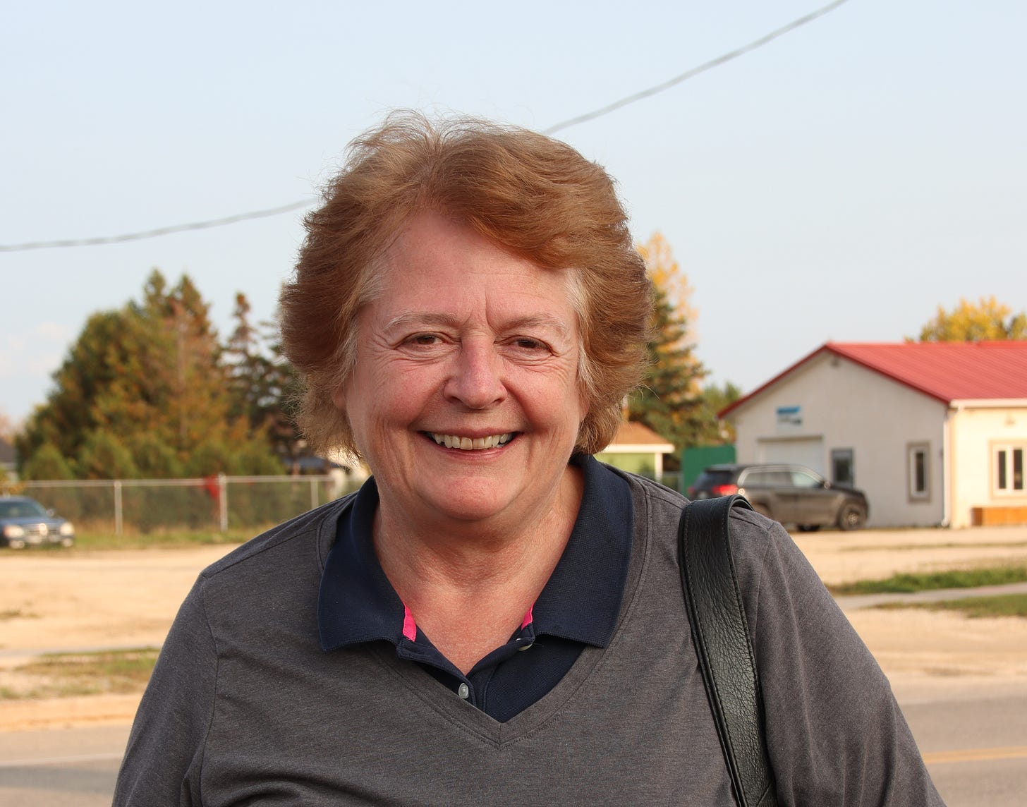 Springfield resident Janet Nylen stands outside near the street in a small rural town, smiling. Springfield resident Janet Nylen stands outside near the street in a small rural town, smiling.