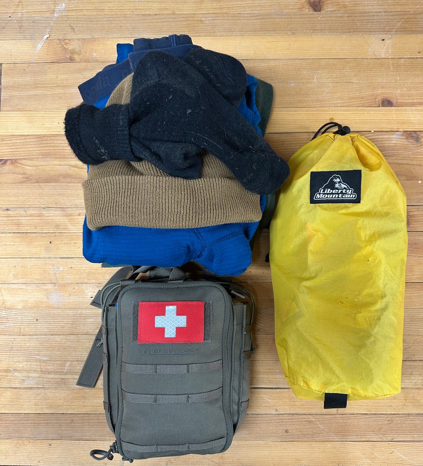 The contents of Jesse McEntee's survival kit, med kit, and extra clothing packed up. The contents of Jesse McEntee's survival kit, med kit, and extra clothing packed up.