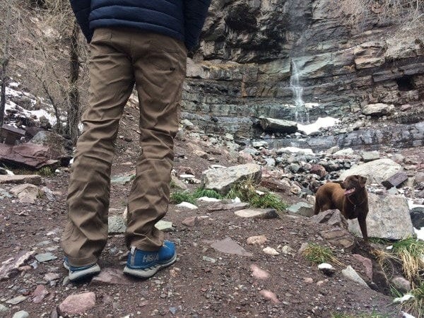 a man wears the prana brion pants standing in front of a waterfall a man wears the prana brion pants standing in front of a waterfall