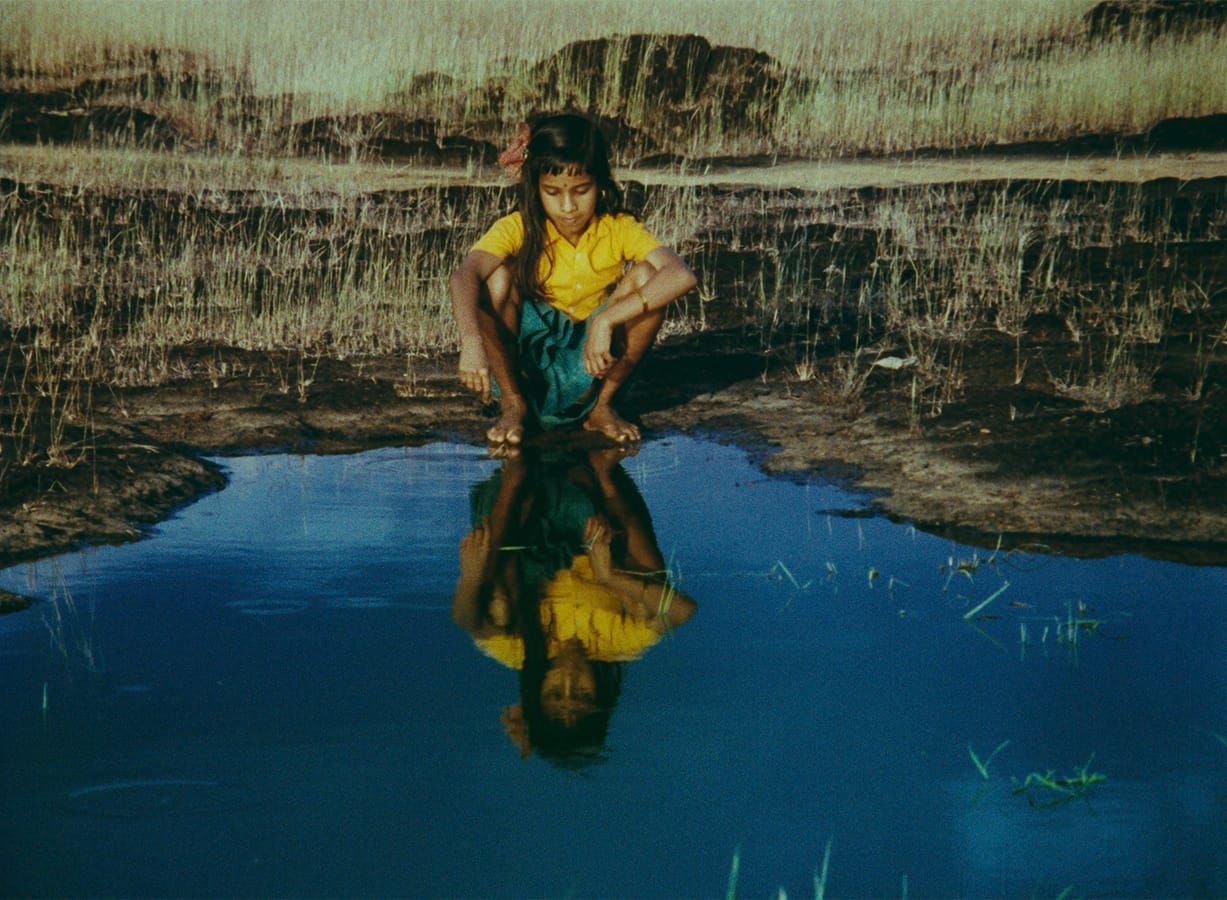 Kummatty | Still features a young girl playing at a pond.