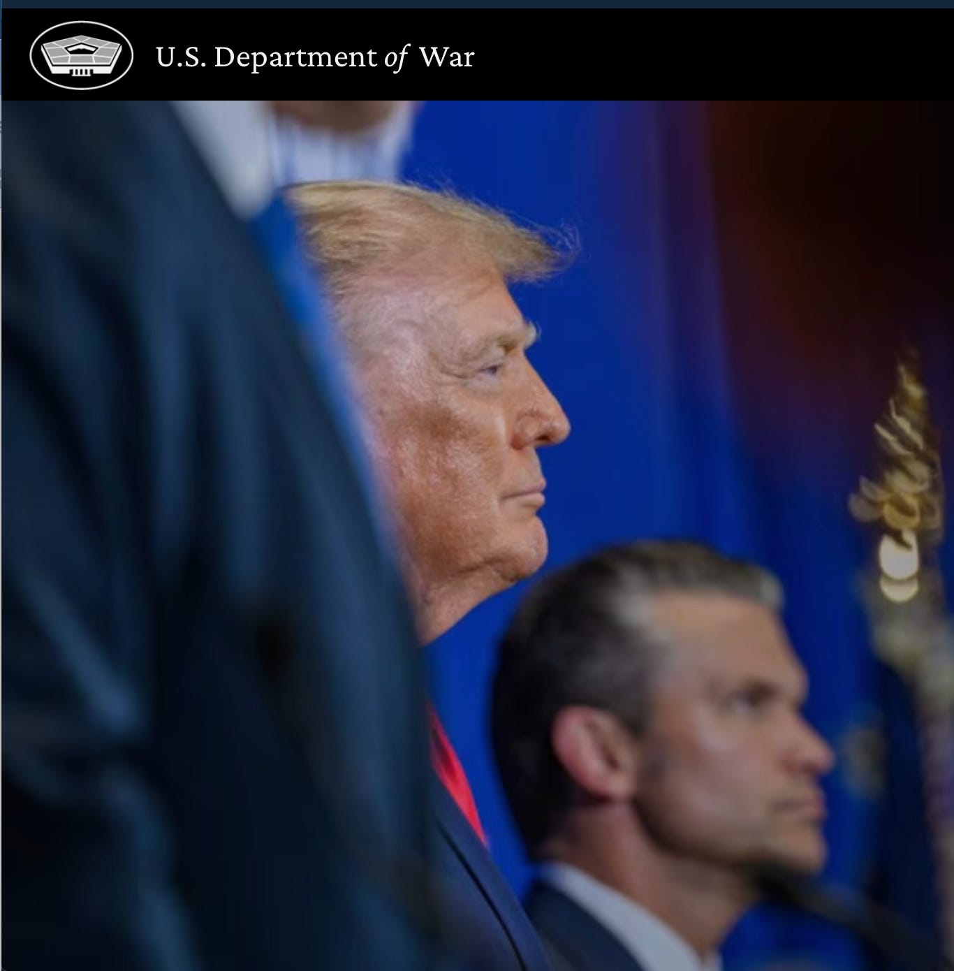 Donald Trump in profile beside Defense Secretary Pete Hegseth, under a U.S. Department of War banner Donald Trump in profile beside Defense Secretary Pete Hegseth, under a U.S. Department of War banner